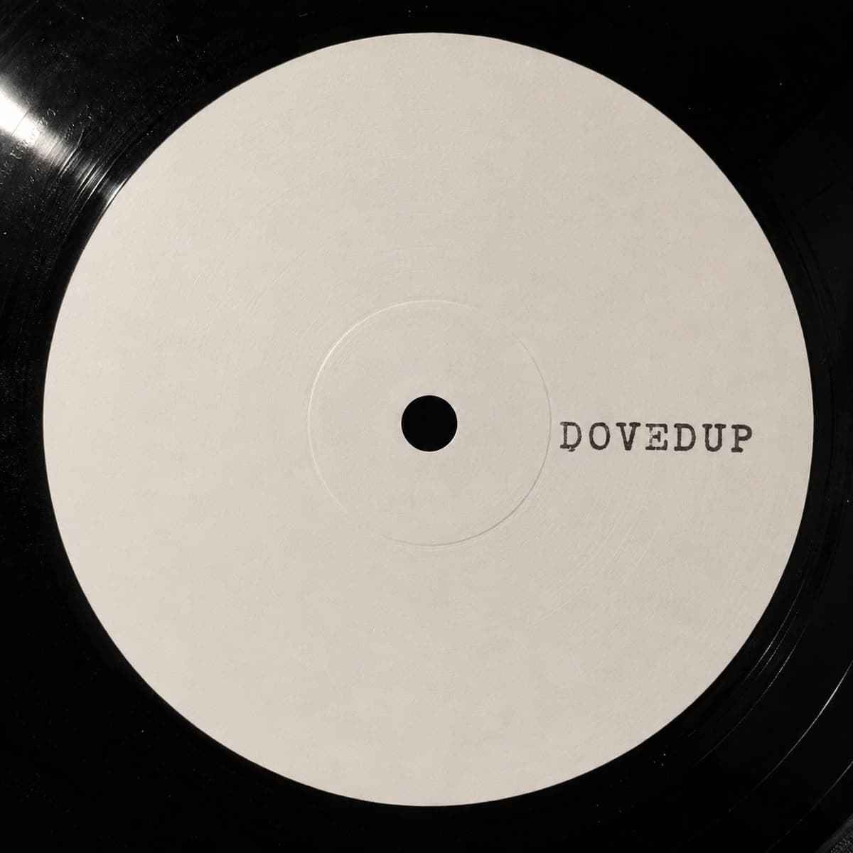 A white-label vinyl record stamped DOVEDUP